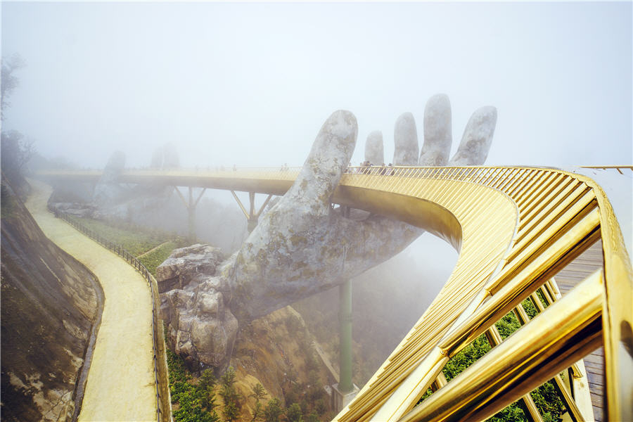 Danang , Vietnam. View in Fog of the Golden Bridge on Ba Na Hills.