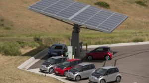 Electric vehicles below solar canopy.