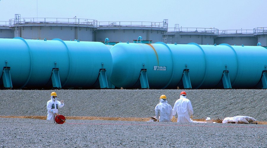 Employees of TEPCO's Fukushima Daiichi nuclear power station work among underground water storage pools