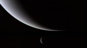 This view of the crescents of Neptune and Triton was acquired by Voyager 2 approximately 3 days, 6 and one-half hours after its closest approach to Neptune.