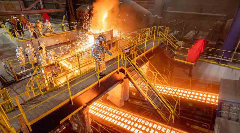 Employees working at the US Steel Gary Works pig iron caster in Indiana