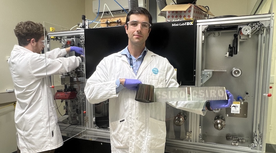 CSIRO renewable energy systems group leader Anthony Chesman holds the printed flexible solar cells.