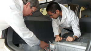 CSIRO engineers refitting a plugin hybrid electric trial car with a larger battery pack and battery charger