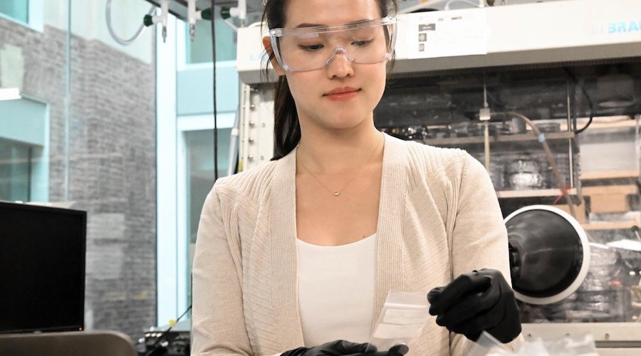 Yi-Chen Lan, doctoral student in chemical engineering at Penn State, holds a battery coin cell that contains composite electrolytes reprocessed through cold sintering.